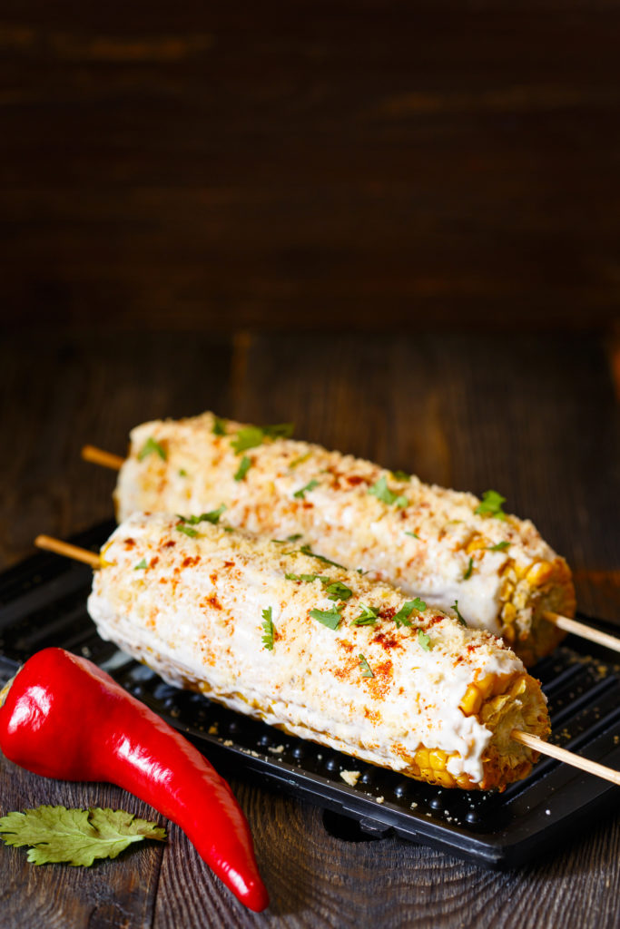 Fresh hot mexican street corn on grill.