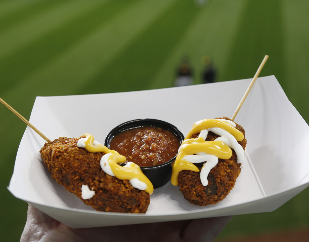 Nachos on a stick are shown before a game between the Milwaukee Brewers and Pittsburgh Pirates at Miller Park on April 10, 2015 in Milwaukee, Wisconsin. They feature a stick of beer, loaded with refried beans, rolled in Doritos and then deep fried and drizzled with sour cream and cheese. (Photo by Jeffrey Phelps/Getty Images)
