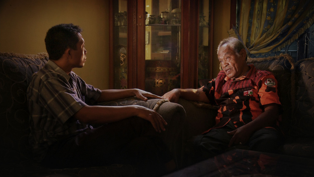 Adi questions Commander Amir Siahaan, one of the death squad leaders responsible for his brother's death during the Indonesian genocide, in Joshua Oppenheimer's documentary "The Look of Silence." Courtesy of Drafthouse Films and Participant Media.