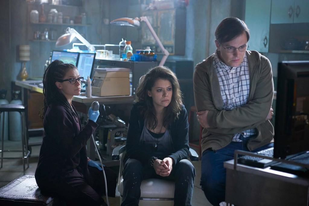 Cosima (Tatiana Maslany), Sarah (Tatiana Maslany), and Cosima's friend/lab partner Scott (Josh Vokey) are also trying to figure out what's going on. (Photo Credit: Ken Woroner for BBC AMERICA)