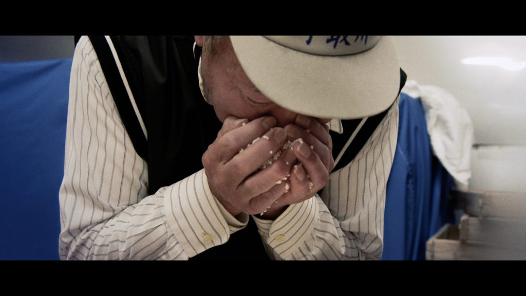 Yamamoto Toji checking Koji rice in "The Birth of Saké." (Photo Credit: Erik Shirai)