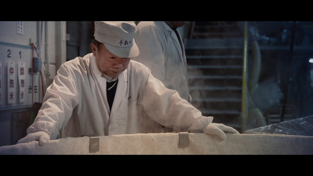 Yamamoto Toji in front of rice vat in "The Birth of Saké." (Photo Credit: Erik Shirai)