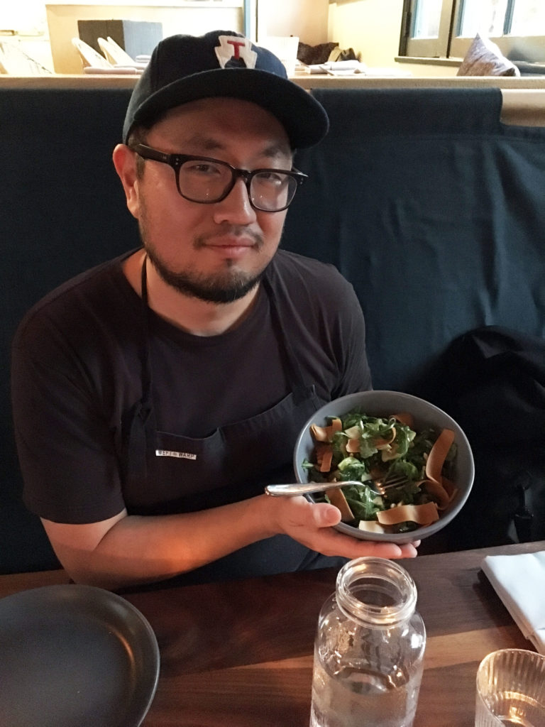 Chef Jason Kim posing with the gjetost-topped salad.