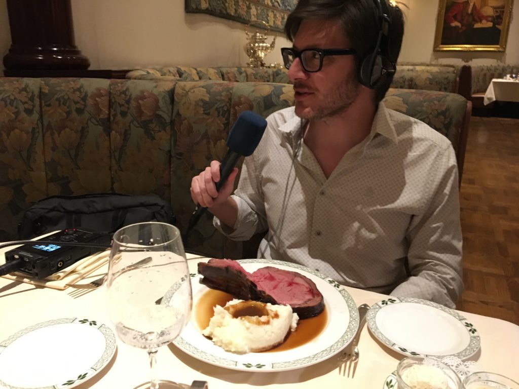 Rico talks with Ryan while his prime rib is waiting to be consumed.