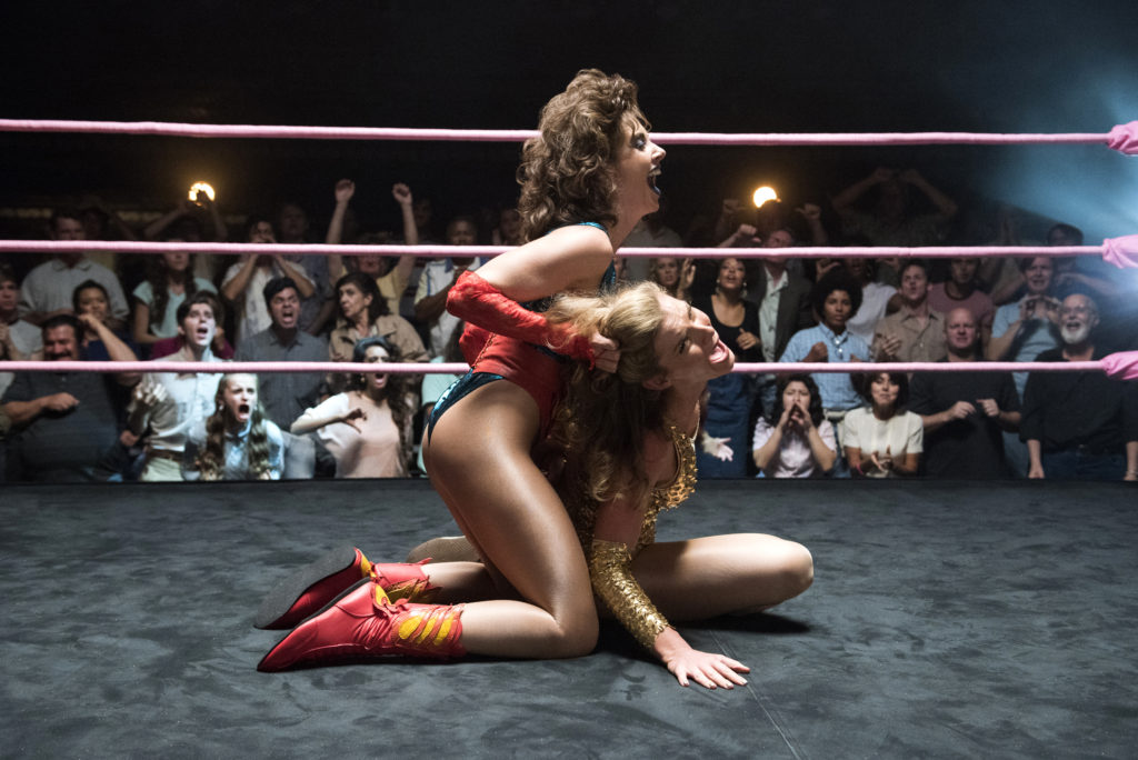 Alison Brie pulls on Betty Gilpin's hair in "GLOW" (Photo Credit: Erica Parise/Netflix)